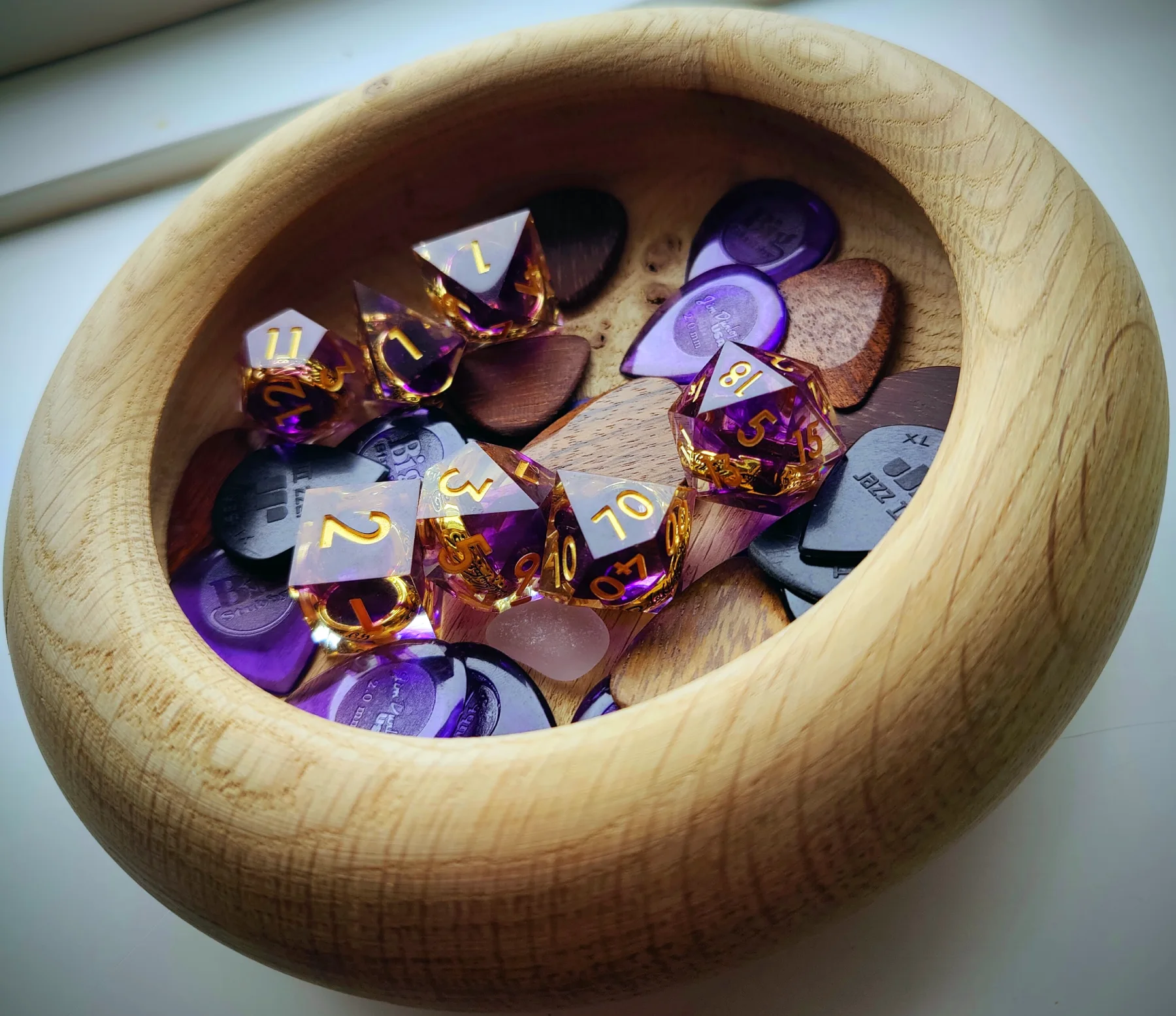 Dice and picks in a bowl made from oak